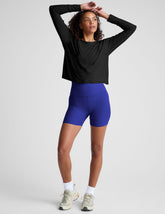 model is wearing blue high-waisted 5" inseam biker shorts.